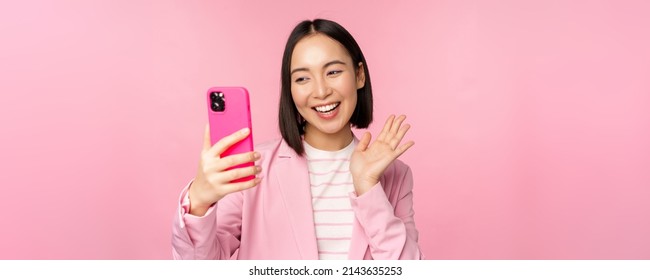 Stylish Asian Businesswoman, Girl In Suit Taking Selfie On Smartphone, Video Chat With Mobile Phone App, Posing Against Pink Studio Background