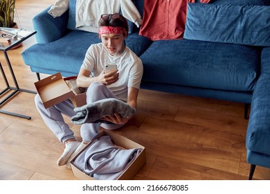 Stylish Asian Guy Holding The Phone And Taking A Photo Of New Clothes