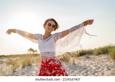 Stylish Attractive Slim Smiling Woman On Beach In Summer Style Fashion Trend Outfit Carefree And Happy, Feeling Freedom, Wearing Red Skirt Boho Style Chic And Fringe Tunic