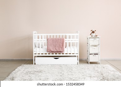 Stylish Baby Bed Near Light Wall In Interior Of Children's Room
