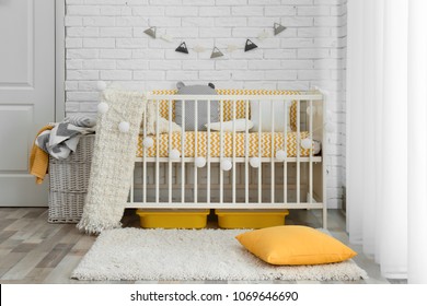 Stylish baby room interior with crib