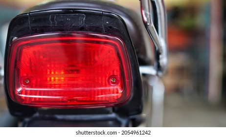 Stylish back light of a two wheeler. Picture of motorcycle red tail light.