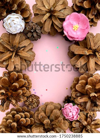 stylish background with pine cones on pink copy space for text. seasonal holidays concept