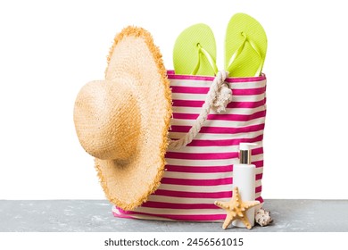 Stylish bag with beach accessories . Summer holiday concept. Top view of beach bag with sunscreen cream with space for text. - Powered by Shutterstock