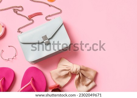 Stylish bag and different accessories on pink background