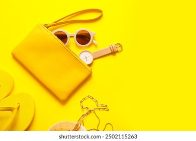 Stylish bag with watch and different accessories on yellow background