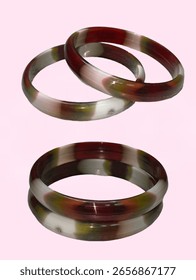Stylish bangles featuring a captivating blend of earthy tones. The bangles showcase a unique marbled pattern with shades of maroon.
Bangles Isolated, plastic bangles.
