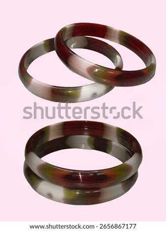 Stylish bangles featuring a captivating blend of earthy tones. The bangles showcase a unique marbled pattern with shades of maroon.
Bangles Isolated, plastic bangles.