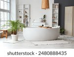 Stylish bathroom with bathtub, shelving unit and window