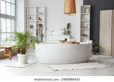 Stylish bathroom with bathtub, shelving unit and window