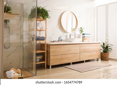Stylish bathroom interior with countertop, mirror and shower stall. Design idea - Shutterstock ID 1654774789