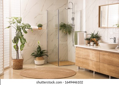 Stylish bathroom interior with countertop, shower stall and houseplants. Design idea - Shutterstock ID 1649446102