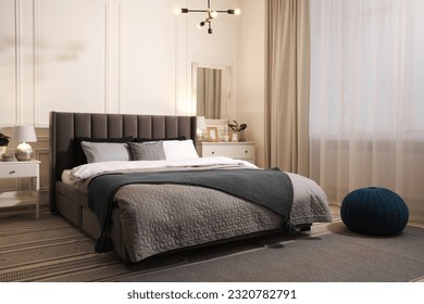 Stylish bedroom interior with large comfortable bed and chest of drawers - Powered by Shutterstock