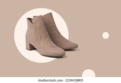 Stylish beige women's suede boots on an abstract beige background. Minimal concept of women's shoes.