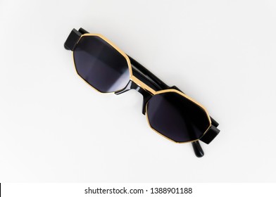 Stylish Black And Gold Sunglasses Isolated On White Background.