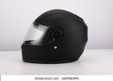 Stylish black motorcycle helmet with wind shield and sun visor, classic helmet isolated on white background