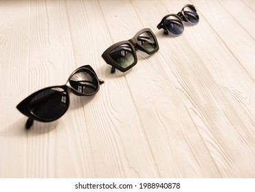 Stylish Black Sunglasses. Summer Background Mockup Template Text. Pattern Top View Above White Wooden Background. Summer Fashion Accessories For Beach. Women Summer Design Sunglasses. Vacation Concept