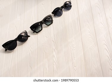 Stylish Black Sunglasses. Summer Background Mockup Template Text. Pattern Top View Above White Wooden Background. Summer Fashion Accessories For Beach. Women Design Sunglasses. Vacation Concept