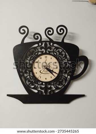A stylish black wall clock displayed on a clean, modern wall, perfect for contemporary home and office interiors. The minimalist design and neutral color make it ideal for living rooms, bedrooms, workspaces, studios, and corporate environments. This elegant wall clock represents time management, productivity, simplicity, and modern lifestyle. Suitable for use in interior design concepts, home decor inspiration, business presentations, advertisements, and social media content.