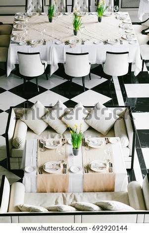 Stylish black and white dining tables and chairs. Minimalist interior in monochrome. Empty restaurant top view. Wedding preparetion