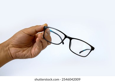 Stylish black-rimmed glasses held in hand, showcasing a modern design perfect for both fashion and function. - Powered by Shutterstock