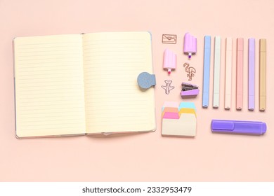 Stylish blank notebook and different school stationery on beige background