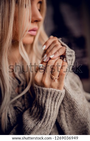 Stylish blonde woman holds hands