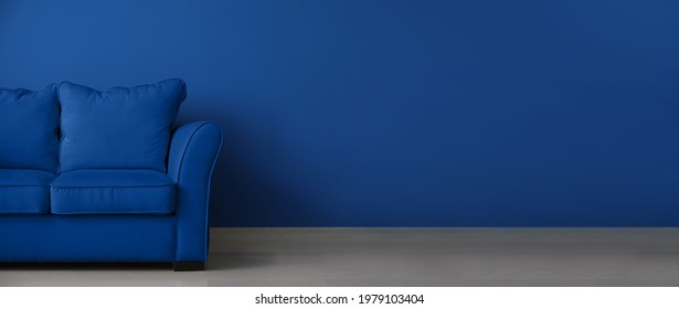 Stylish Blue Sofa Near Color Wall 