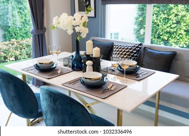 Stylish blue and white dining room with table set ready for a nice meal
