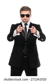 Stylish Bodyguard Pointing His Forefingers At Viewer. Isolated On A White Background