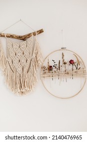 Stylish Boho Wreath With Dry Flowers And Macrame Hanging On White Wall. Modern Floral Arrangement And Creative Handmade Decor In Modern Boho Room