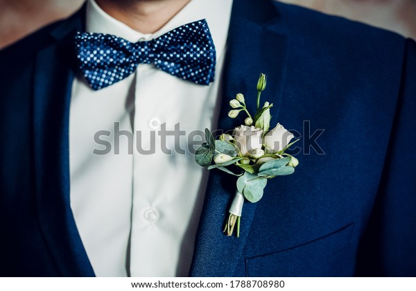 stylish boutonniere on the\
groom\'s jacket, wedding day, beautiful flower boutonniere, wedding\
concept