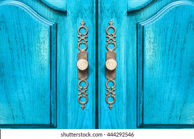 Stylish Brass Door Handles On A Hardwood Cabinet Or Closet With Ornate Escutcheons And Raised Panels On The Doors In A Close Up Frontal View Conceptual Of Furnishing And Interior Decor