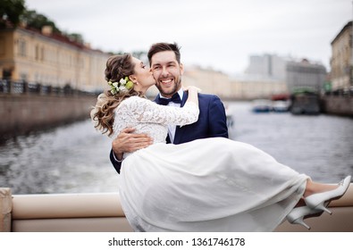 Stylish Bride And Groom On Their Wedding Day, Having Fun And Smiling On A Boat Trip On The River