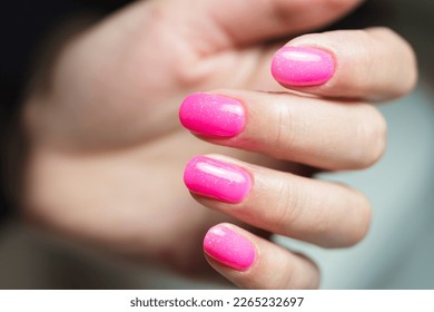 Stylish bright female pink manicure.  Manicure with gel polish close-up