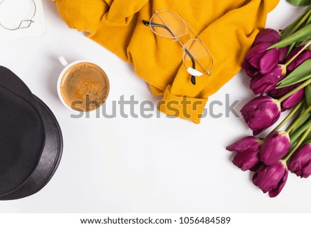 Stylish and bright feminine accessories and purple tulips, top view