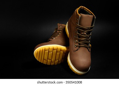 stylish brown nubuck mens boots on black background, advertising concept - Shutterstock ID 350541008