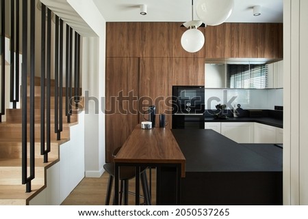 Stylish brown panel kitchen interior with biuld-in kitchen and kitchen island and personal accessories. Geometric forms and shapes. Template. 