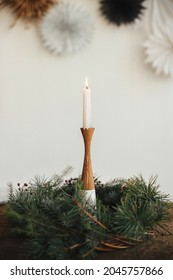 Stylish Burning Candle In Rustic Christmas Wreath On Wooden Table On Background Of Paper Swedish Stars On Wall. Christmas Advent. Moody Atmospheric Time. Merry Christmas And Happy Holidays!