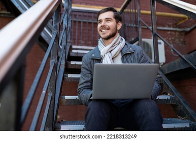 Stylish Business Man With A Laptop On His Knees Sitting On The Stairs In The Office, Entrepreneurship Development And Business Planning Concept