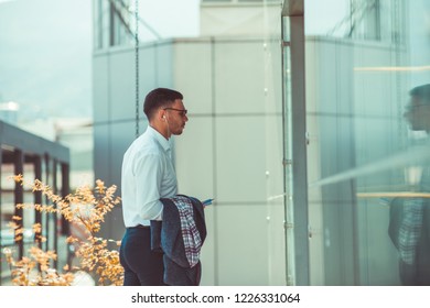 Stylish Businessman Wearing White Shirt Enter In His Office In The Building. Urban Businessman On The Move