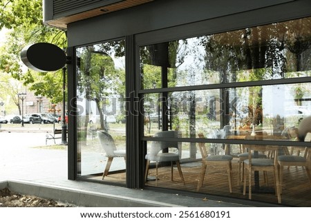 Stylish cafe with large windows, view from outdoors