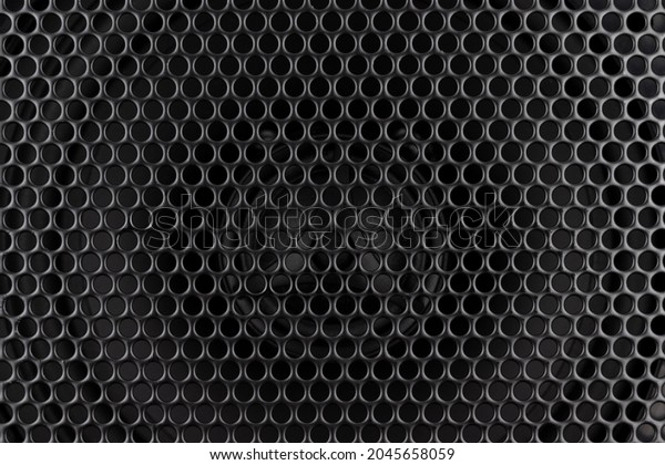 Stylish\
car audio acoustic round speaker with waffle grill protector cover\
closeup. Modern music black background\
texture