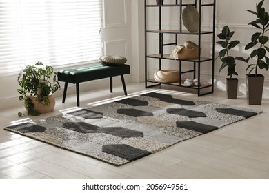 Stylish carpet with pattern on floor in room