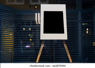 Stylish chalkboard with mock up copy space are for your text message or advertising promotional content, empty presentation wooden board standing on the glass storefront