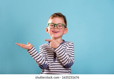 Stylish Child Boy With Open Palm And Finger Pointed Up. Promoting School Supplies