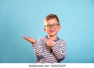 Stylish Child Boy With Open Palm And Finger Pointed Up. Promoting School Supplies