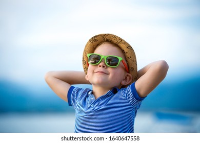 Stylish Child Boy In Sunglasses Near Palm. Cool Kid On Summer Vacation