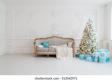 Stylish Christmas Interior With An Elegant Sofa. Comfort Home. Presents Gifts Underneath The Tree In Living Room