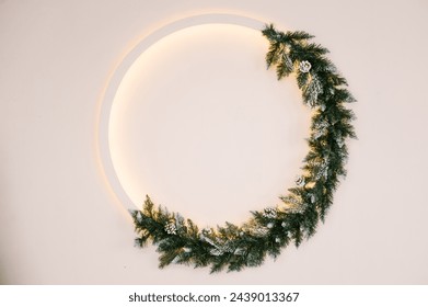 Stylish Christmas wreath with backlight on a white wall background, New Year decor, empty space for text - Powered by Shutterstock